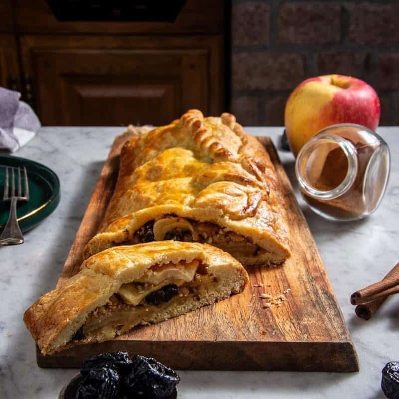 prune apple strudel on a wooden board