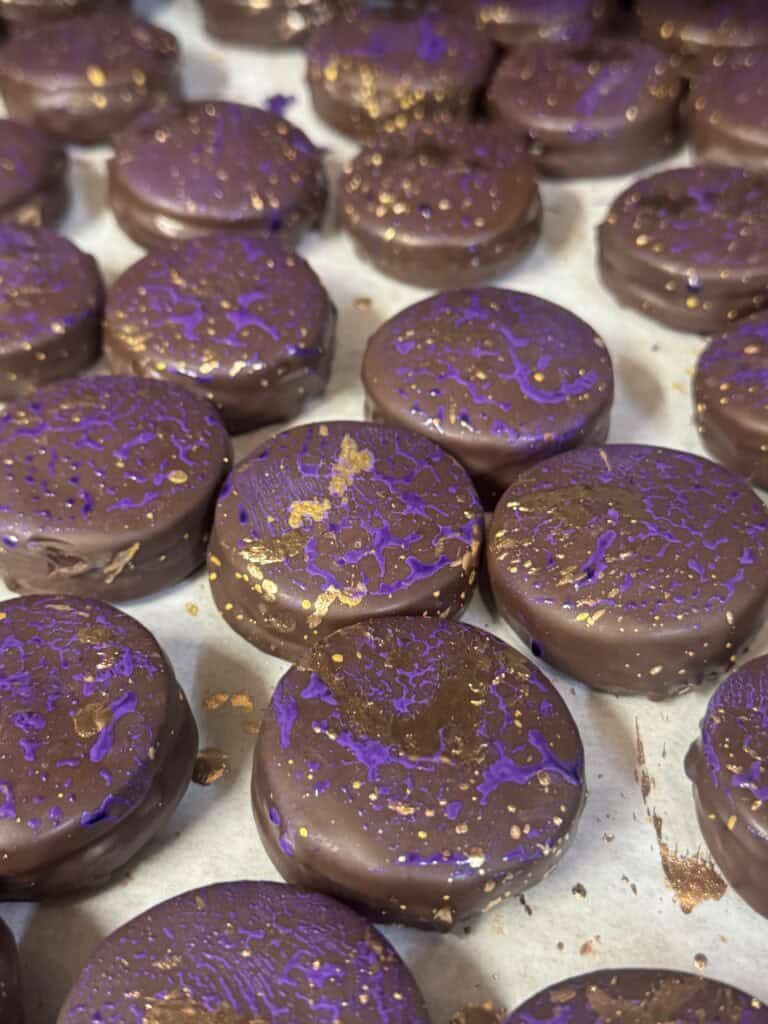 chocolate glazed sandwich cookies on a tray
