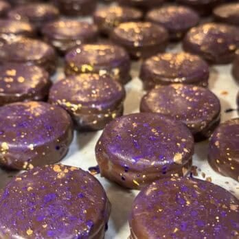 chocolate glazed sandwich cookies on a tray