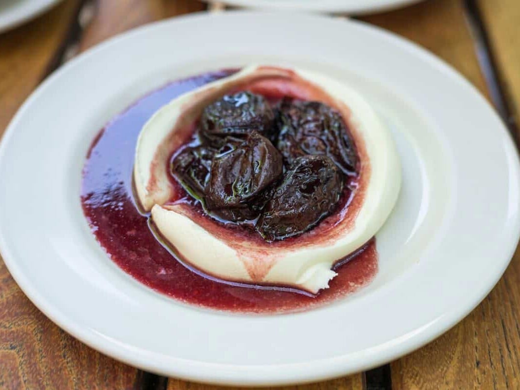 red wine prunes on top of mascarpone cream at frankies spuntino