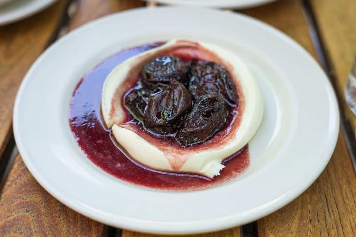 red wine prunes on top of mascarpone cream at frankies spuntino
