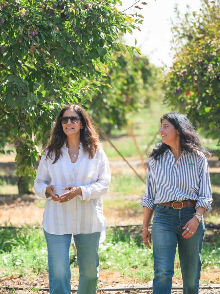 Sureena and Manpreet walking through their Yuba City orchard
