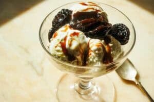 prunes caramelized in olive oil on top of vanilla ice cream