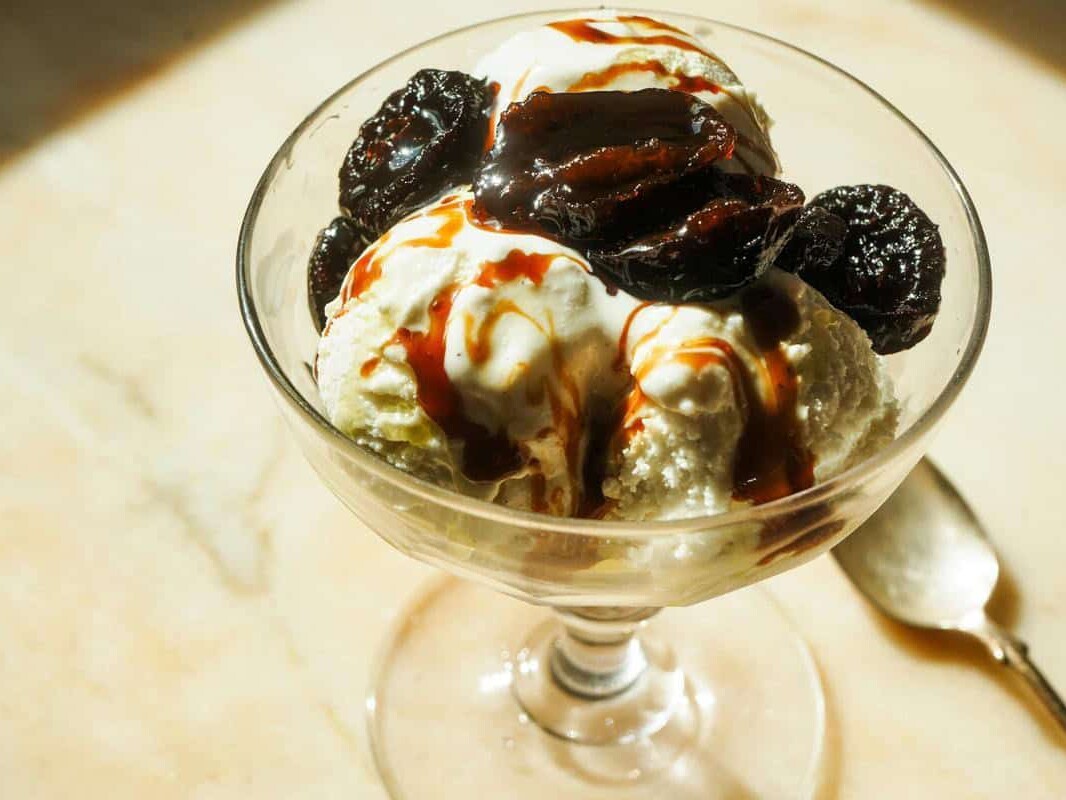 prunes caramelized in olive oil on top of vanilla ice cream
