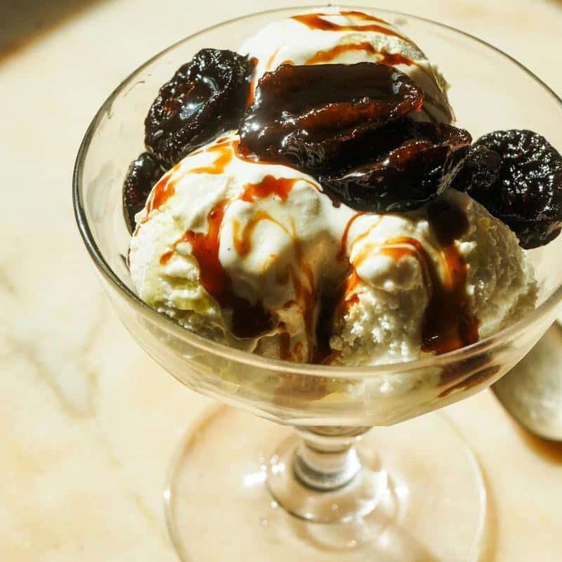 prunes caramelized in olive oil on top of vanilla ice cream