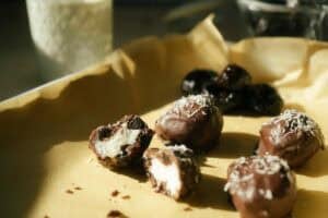 coconut bonbons on a parchment lined baking sheet