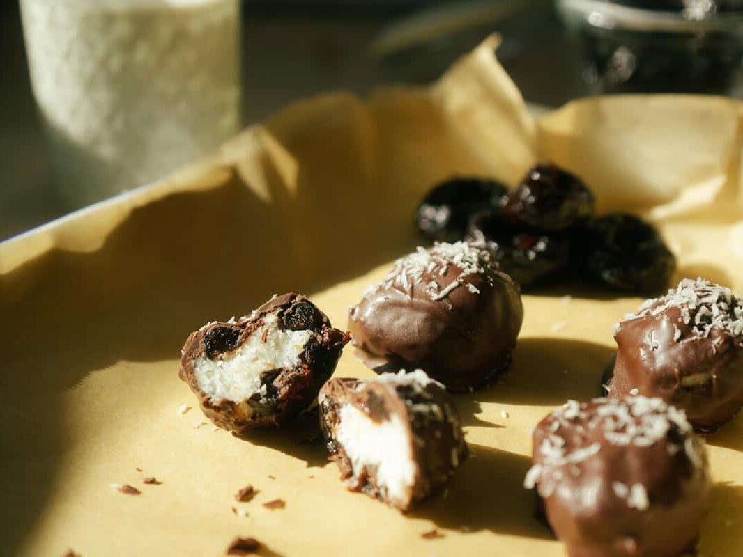 coconut bonbons on a parchment lined baking sheet