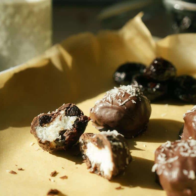 coconut bonbons on a parchment lined baking sheet