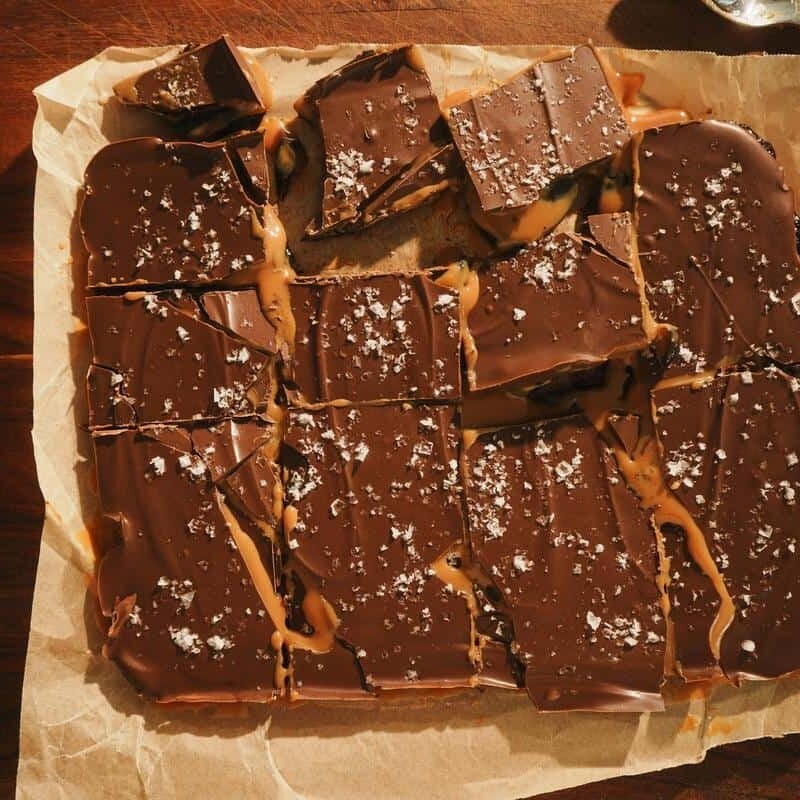 dulce de leche chocolate bars sliced on parchment paper