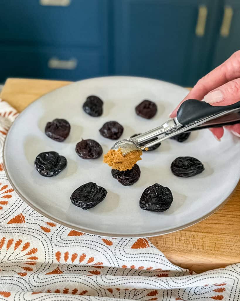 scooping pumpkin spice cookie dough into prune cups