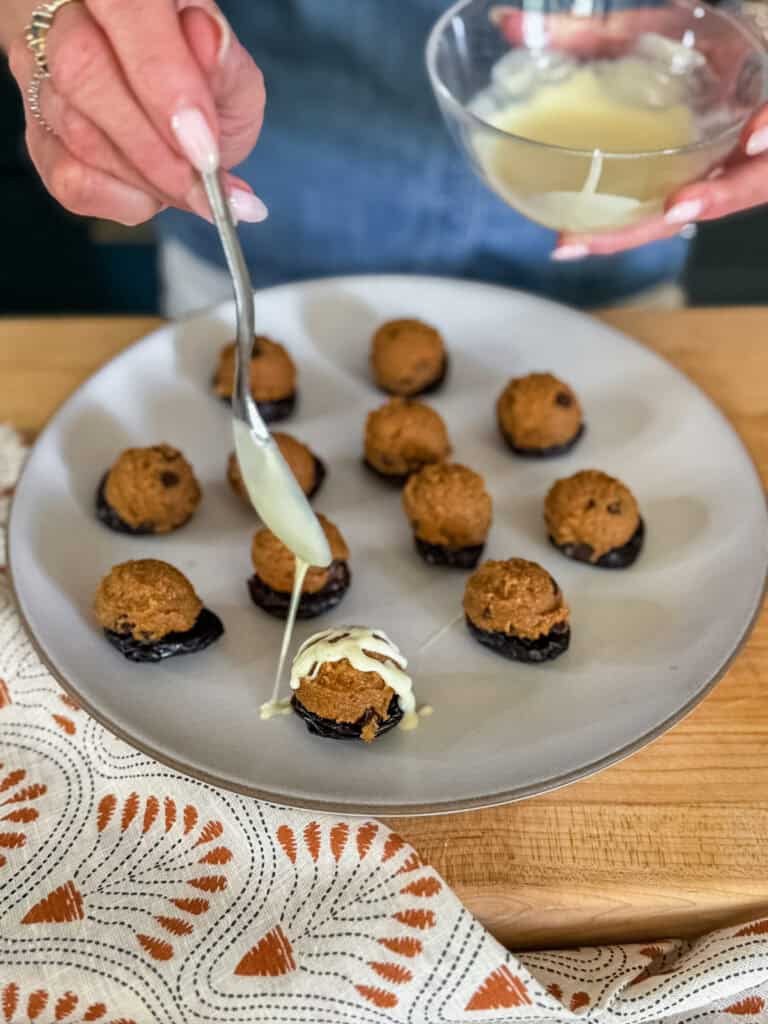 woman drizzling chocolate on a cookie dough bite