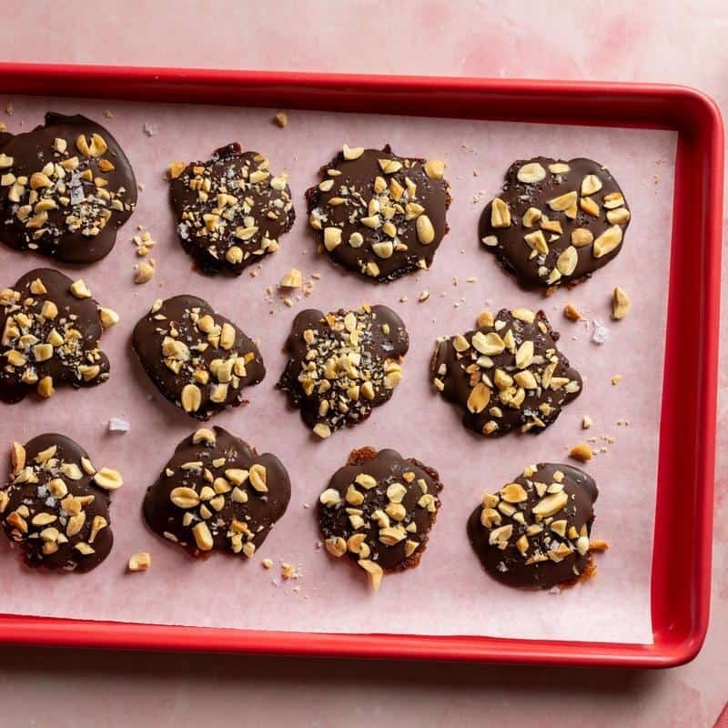 snickers bites on a red baking sheet